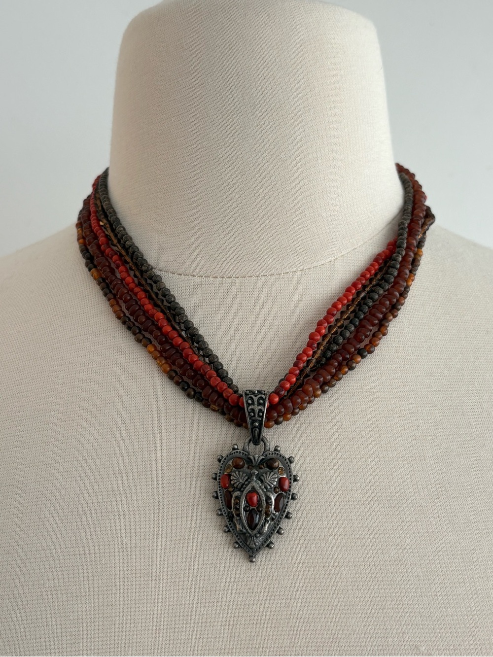 Boho red & brown beaded necklace with heavy silver-tone studded heart pendant